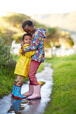 Buy stock photo Shot of a brother and sister hugging together outside