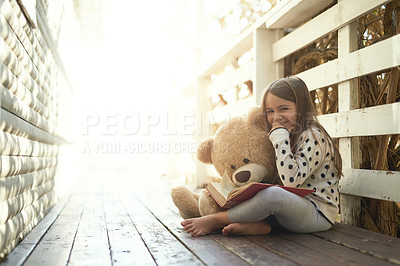 Buy stock photo Outdoor, book and portrait of girl with teddy bear on floor for storytelling, education and learning. Boardwalk, ground and kid with story in backyard for playful, knowledge and child development