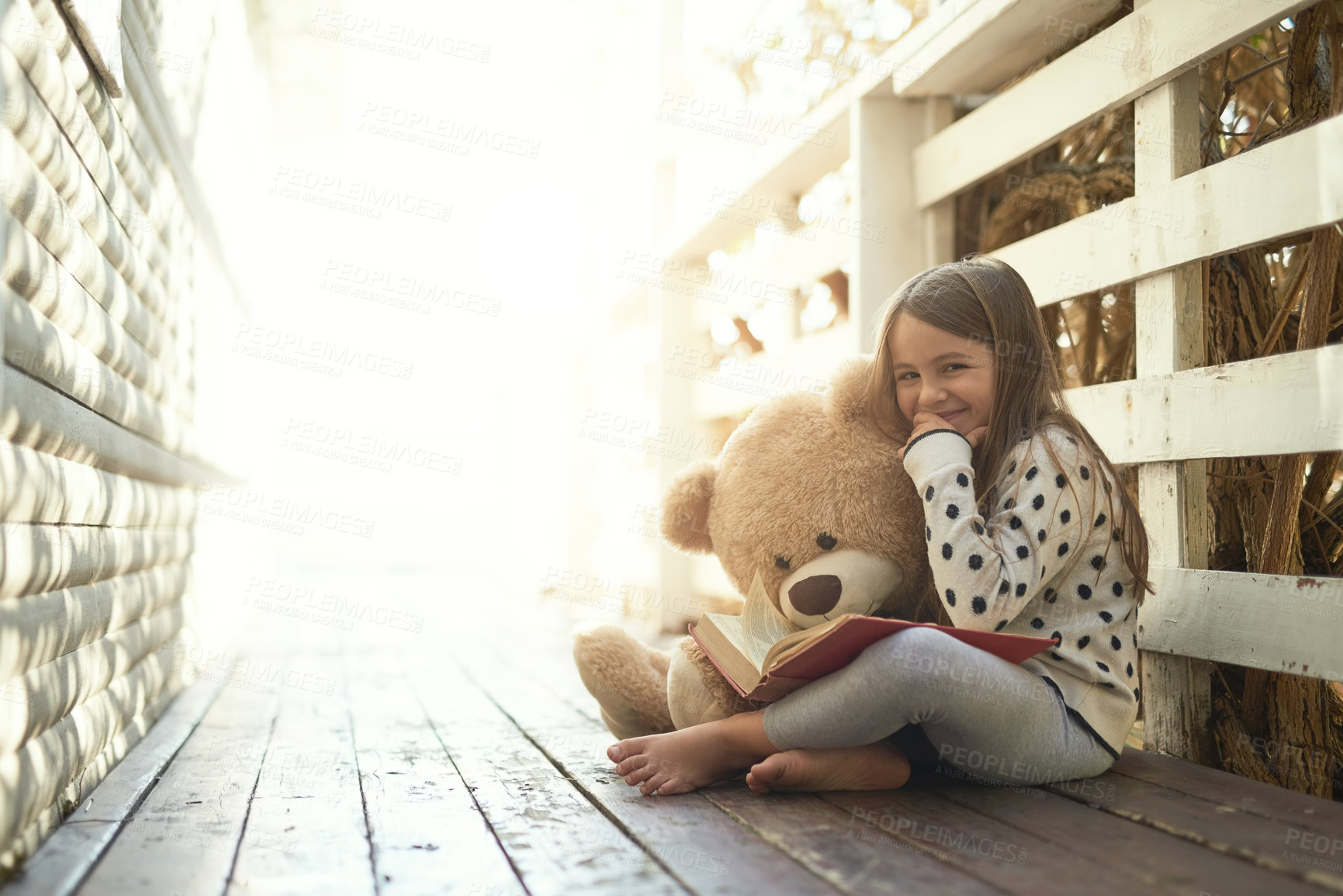 Buy stock photo Outdoor, book and portrait of girl with teddy bear on floor for storytelling, education and learning. Boardwalk, ground and kid with story in backyard for playful, knowledge and child development