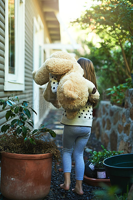 Buy stock photo Rear view shot of a little girl carrying her teddy bear outside