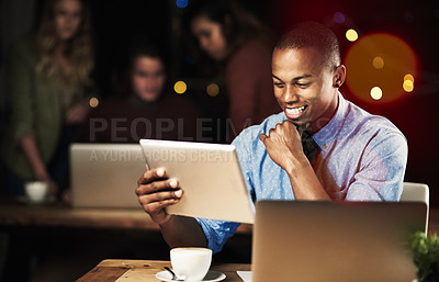 Buy stock photo Shot of a handsome young man working late in the office