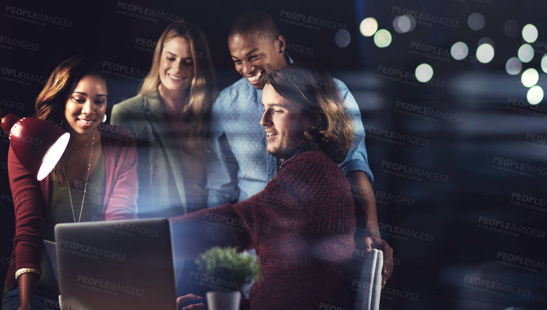 Buy stock photo Shot of a group of colleagues working late in the office together