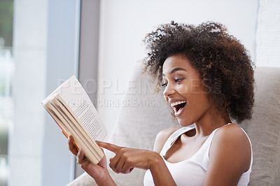 Buy stock photo Happy, black woman and reading with book on sofa for novel, story or literature in living room at home. African female person with surprise for information, news or interesting knowledge at the house