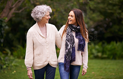 Buy stock photo Care, park and woman walking with elderly mother together on a outdoor vacation or holiday bonding in happiness. Retirement, women and young happy female person in conversation and laughing with mom
