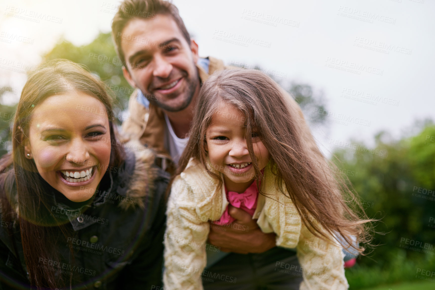 Buy stock photo Smile, parents and child in portrait in park with love, bonding and support at outdoor family adventure. Mom, dad and girl on playful walk in garden together with happy man, woman and kid in nature