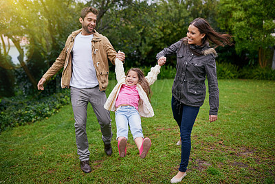 Buy stock photo Mother, father and child holding hands in park with love, bonding and support at outdoor family adventure. Smile, parents and girl playing in garden together with happy man, woman and kid in nature