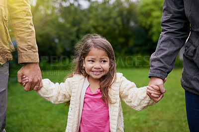 Buy stock photo Smile, parents and child holding hands in park with care, support and trust on outdoor adventure. Love, fun and face of girl with family in garden for happy holiday, nature or walking in backyard