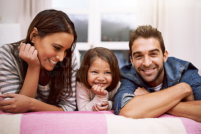 Buy stock photo Portrait, family or smile in bed to relax, love or trust in diversity, bonding or together in house. Papa, mama or girl child as happy, multiracial or adoption as playful, positive or cozy in bedroom