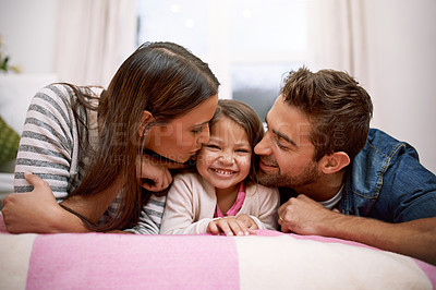 Buy stock photo Kiss, parents or kid in bed to smile, lying or relax as happy, hug or bonding together in house. Young family, cheek or care to embrace, playful or parenting in childhood on joyful, break or getaway