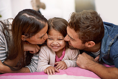 Buy stock photo Kiss, parents or girl to love, lying or bed as happy, hug or memory of bonding together in house. Papa, mama or child as cheek, care or embrace in playful, parenting or childhood on joyful vacation