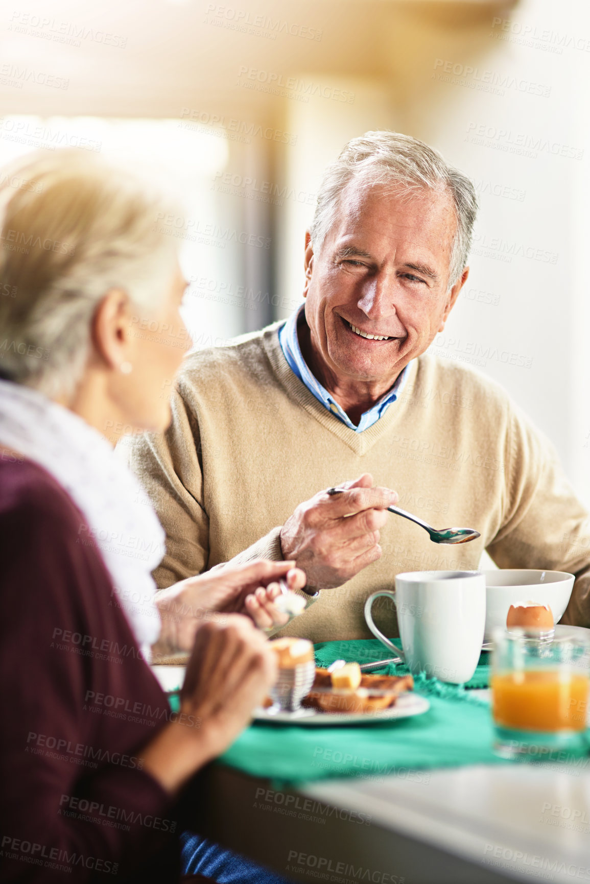 Buy stock photo Shot of a happy senior couple enjoying breakfast together at home