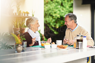 Buy stock photo Shot of a happy senior couple enjoying breakfast together at homet