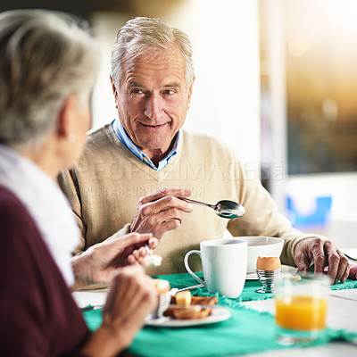 Buy stock photo Shot of a happy senior couple enjoying breakfast together at home