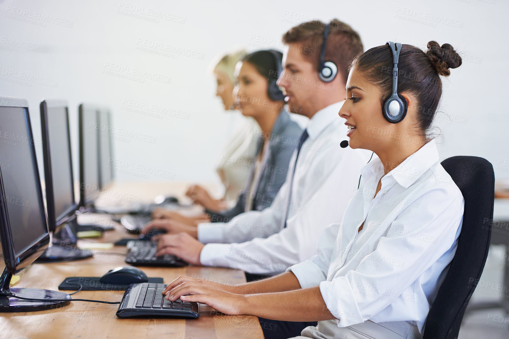 Buy stock photo Help desk, team and phone call with women, men and typing on computer at customer support. Headset, telemarketing and client service agent at callcenter with online consultation in coworking space	