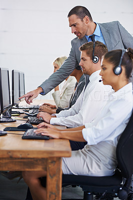 Buy stock photo Help desk, management and row of women, men and typing on computer at customer support. Headset, telemarketing and client service agent at callcenter for online consultation, team or checking quality