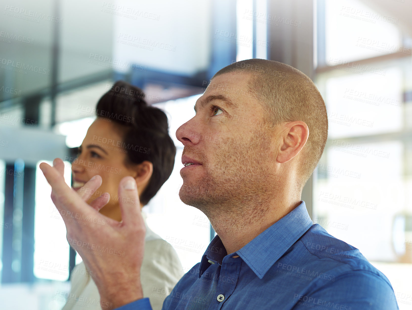 Buy stock photo Shot of two coworkers having a brainstorming session