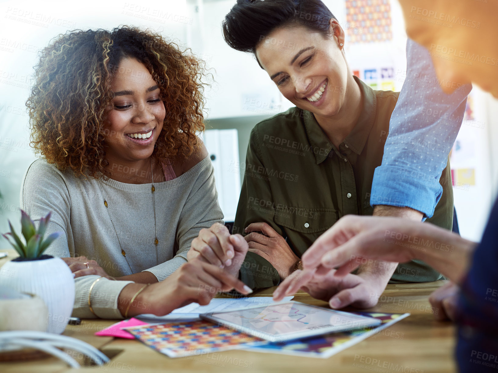 Buy stock photo Cropped shot of coworkers discussing something on a tablet