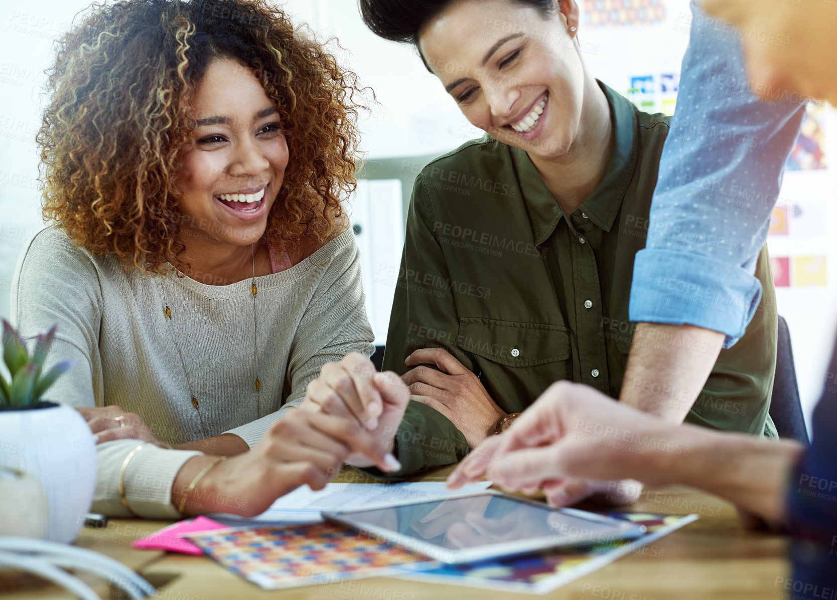 Buy stock photo Cropped shot of coworkers discussing something on a tablet