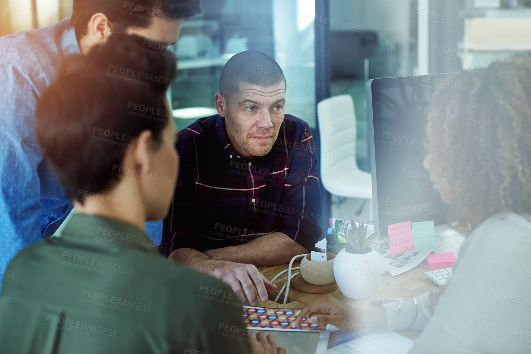 Buy stock photo Shot of colleagues working together in a modern office