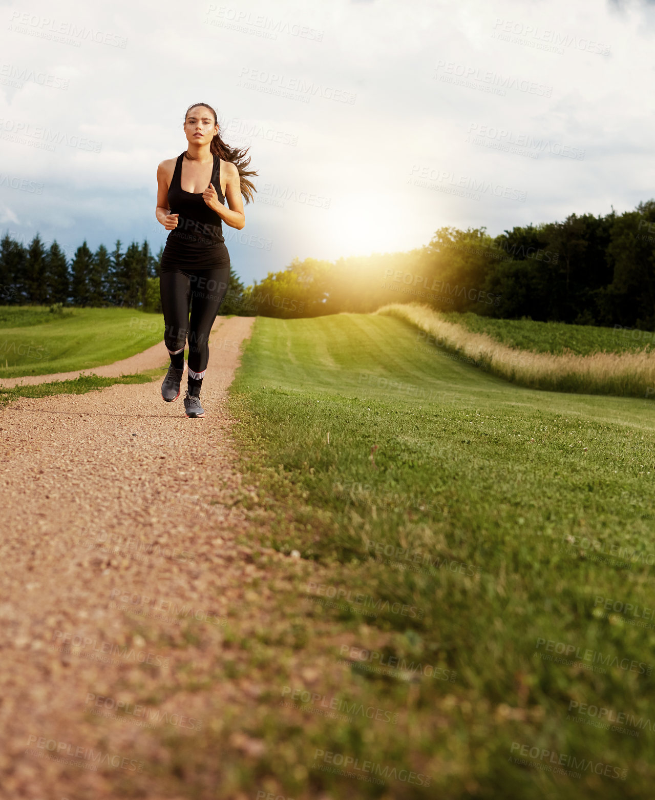 Buy stock photo Shot of a fit young woman out for a run on a beautiful day