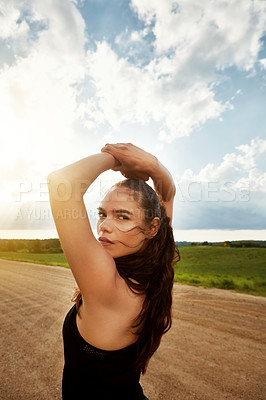 Buy stock photo Shot of a fit young woman getting some exercise outside on a beautiful day