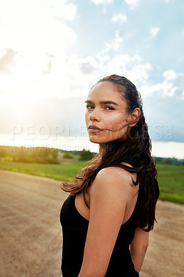 Buy stock photo Shot of a fit young woman getting some exercise outside on a beautiful day