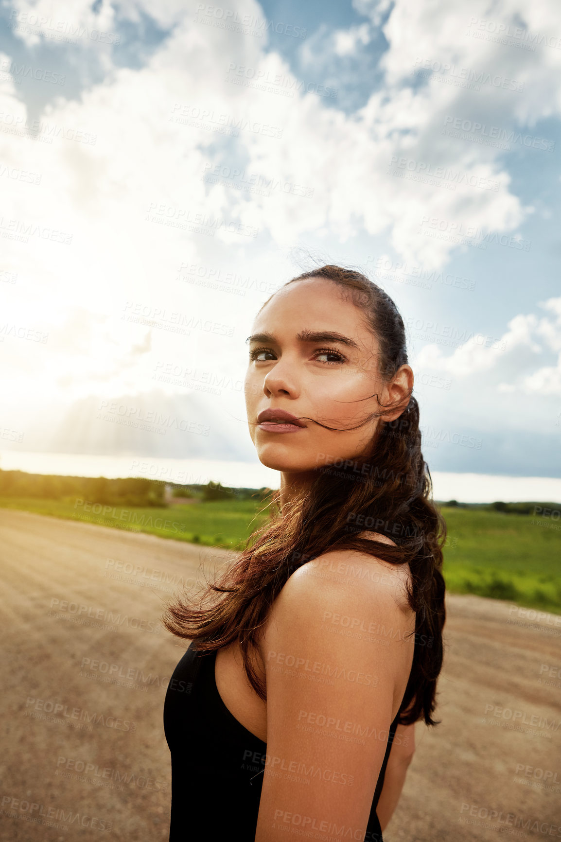 Buy stock photo Shot of a fit young woman getting some exercise outside on a beautiful day