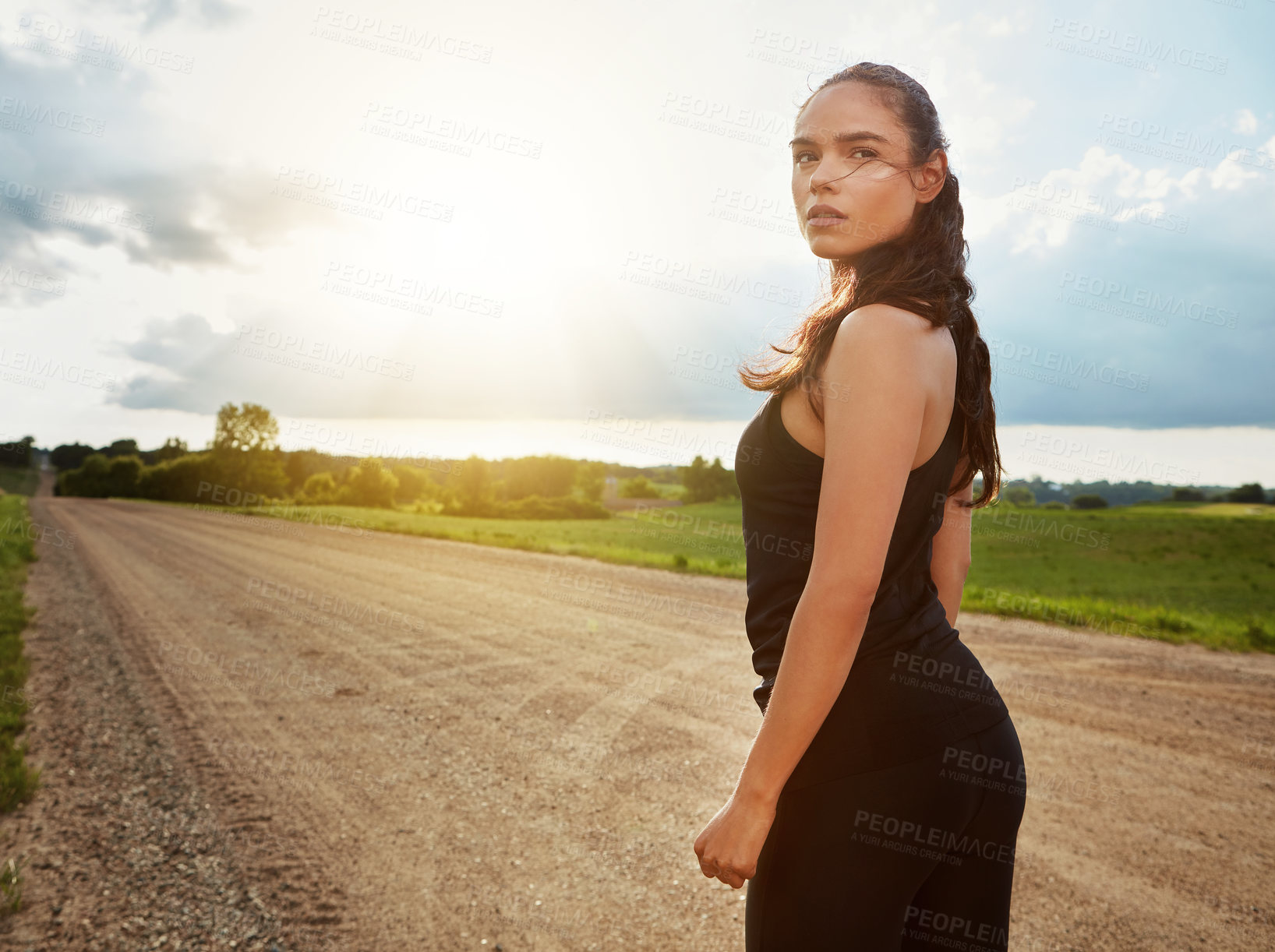 Buy stock photo Shot of a fit young woman out for a run on a beautiful day