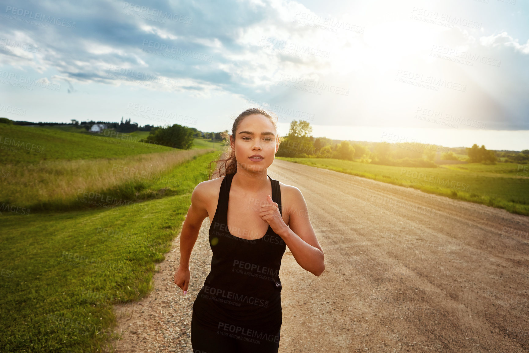 Buy stock photo Shot of a fit young woman power walking outside on a beautiful day