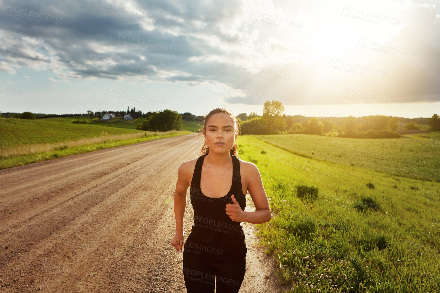 Buy stock photo Shot of a fit young woman power walking outside on a beautiful day