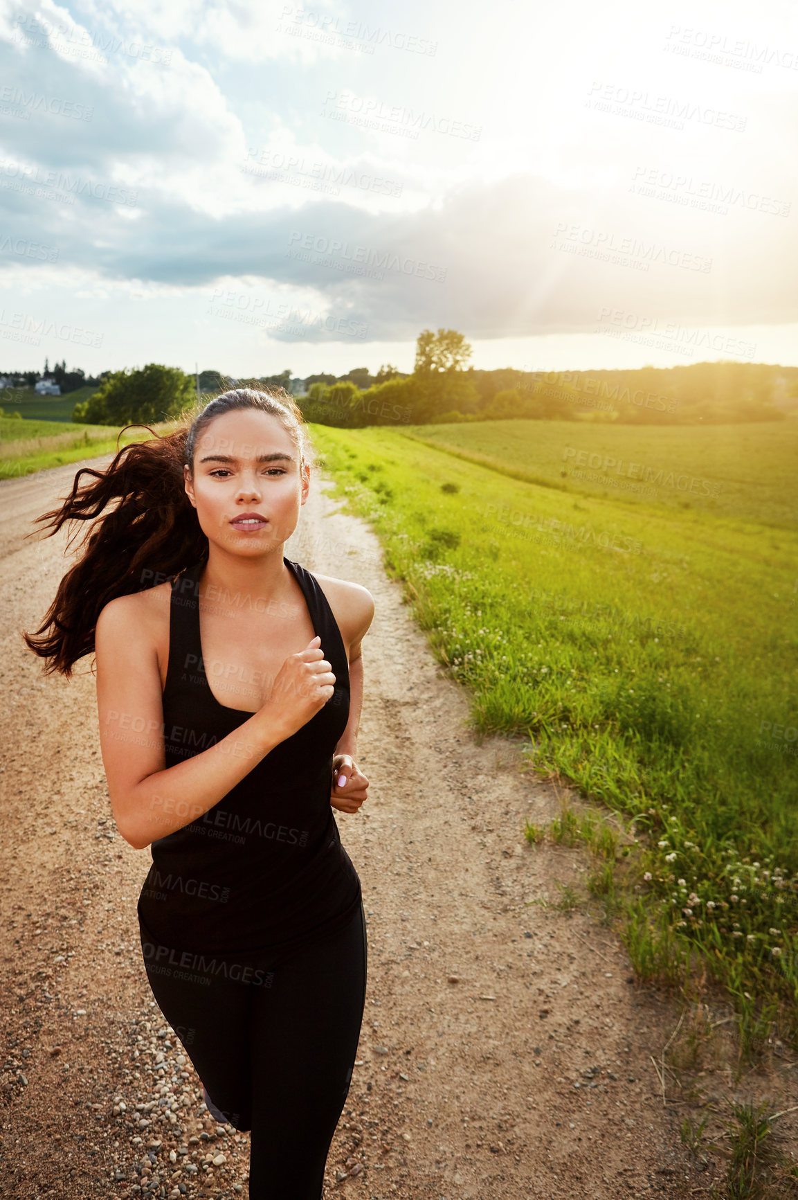 Buy stock photo Shot of a fit young woman power walking outside on a beautiful day