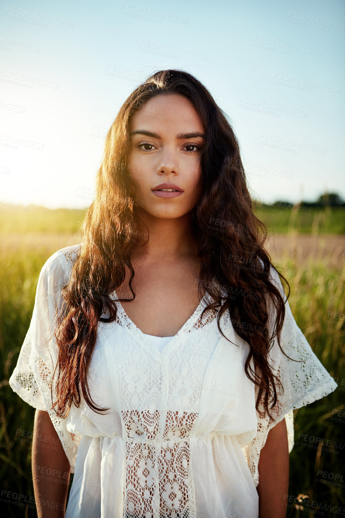 Buy stock photo Portrait of an attractive young woman standing outside in a field