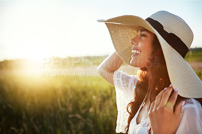 Buy stock photo Shot of an attractive young woman standing outside in a field