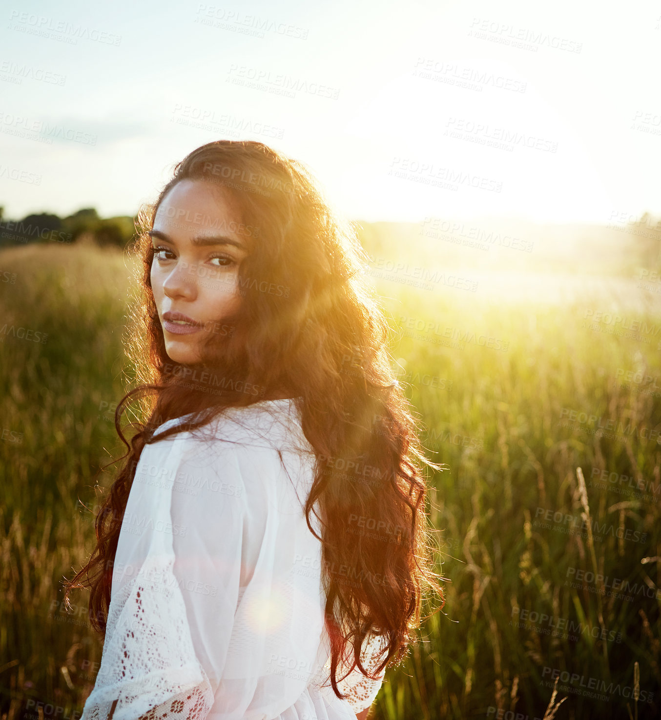 Buy stock photo Portrait of an attractive young woman standing outside in a field