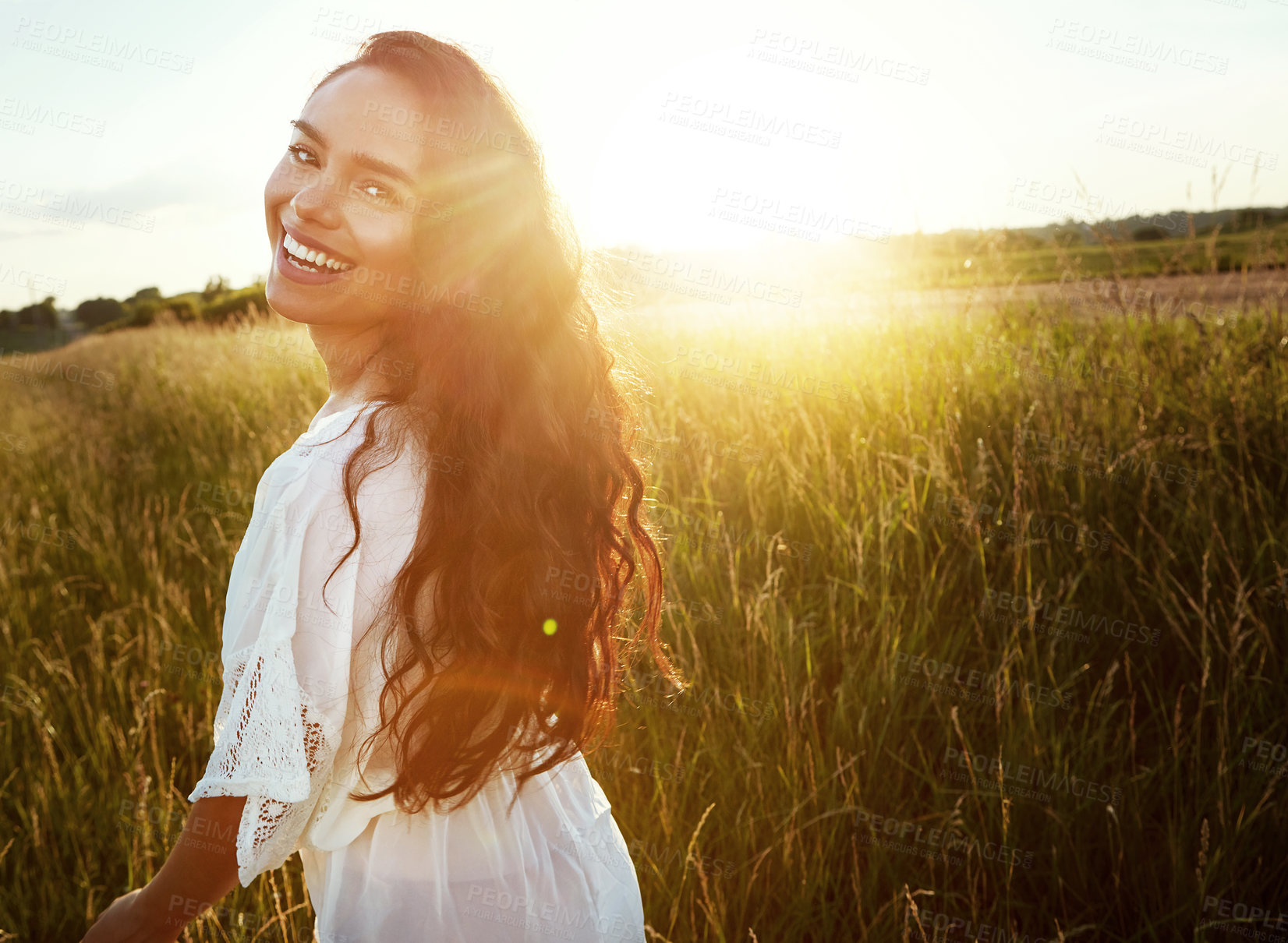 Buy stock photo Portrait of an attractive young woman standing outside in a field