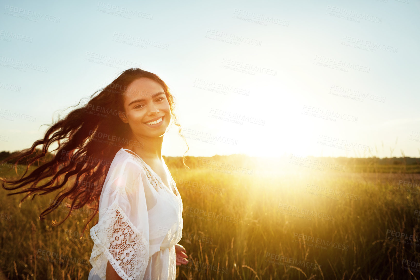 Buy stock photo Portrait of an attractive young woman standing outside in a field