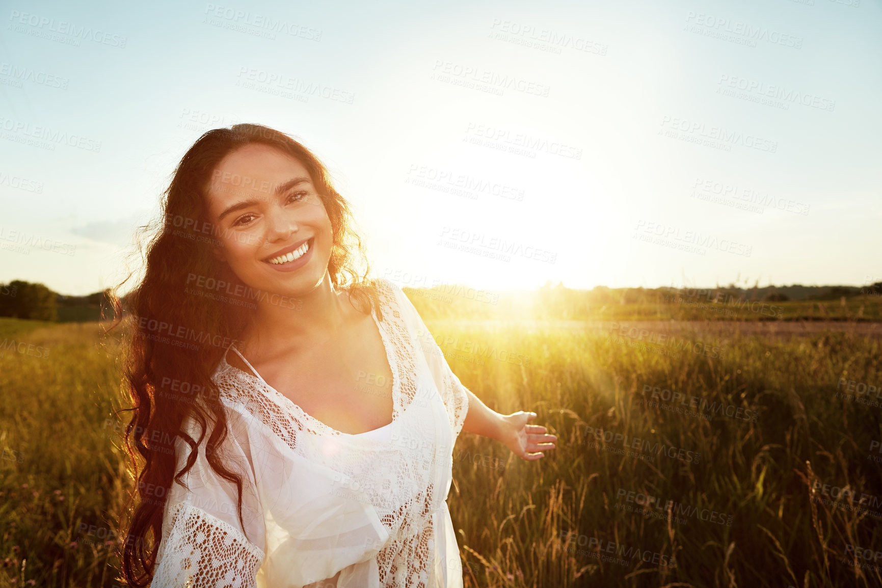 Buy stock photo Portrait of an attractive young woman standing outside in a field