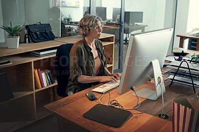 Buy stock photo Cropped shot of a mature businesswomen working on a computer in an office