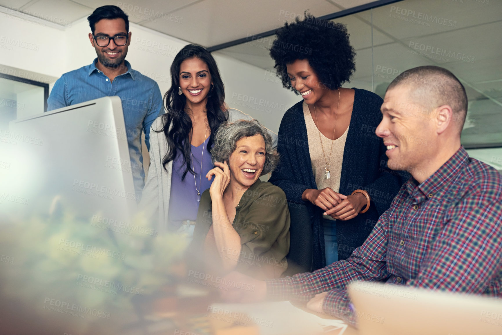 Buy stock photo Cropped shot of a group of businesspeople discussing something on a computer in an office