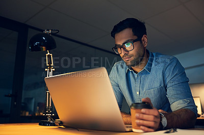 Buy stock photo Cropped shot of a young businessman working late on a laptop in an office