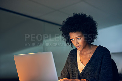 Buy stock photo Cropped shot of a young businesswoman working late on a laptop in an office