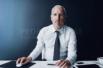 Buy stock photo Cropped shot of a mature businessman working on his computer