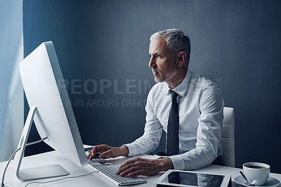 Buy stock photo Typing accountant, computer and elderly man in studio, working and isolated on a dark background mockup. Focus, writing or serious executive at desktop for reading email, research or business auditor
