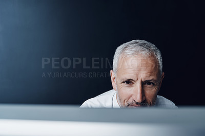 Buy stock photo Technology, man working on his computer and against a studio background. Connectivity or social networking, research or website and mature businessman browsing internet at desktop in backdrop 