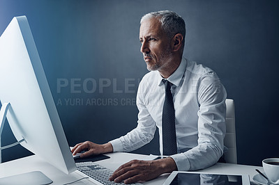 Buy stock photo Typing accountant, computer and senior man in studio, working and isolated on a dark background mockup. Focus, writing and serious manager at desktop for reading email, research or business auditor.