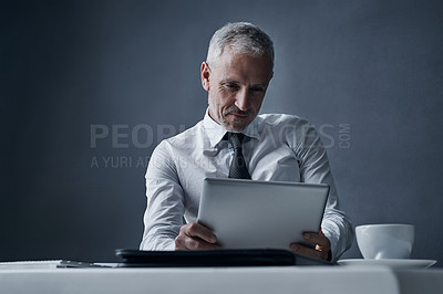 Buy stock photo Tablet, accountant and mature business man in studio isolated on a dark background mockup space. Technology, reading and senior manager at desk for working on project, audit email or research app.