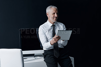 Buy stock photo Tablet, office and business man on black background for social media, internet and website at desk. Thinking, corporate and happy senior male person on digital tech for research, email and planning