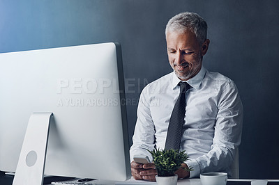 Buy stock photo Phone, computer and business man typing online for social media, internet and website in office. Networking, corporate worker and mature male person on smartphone, chatting and planning at desk