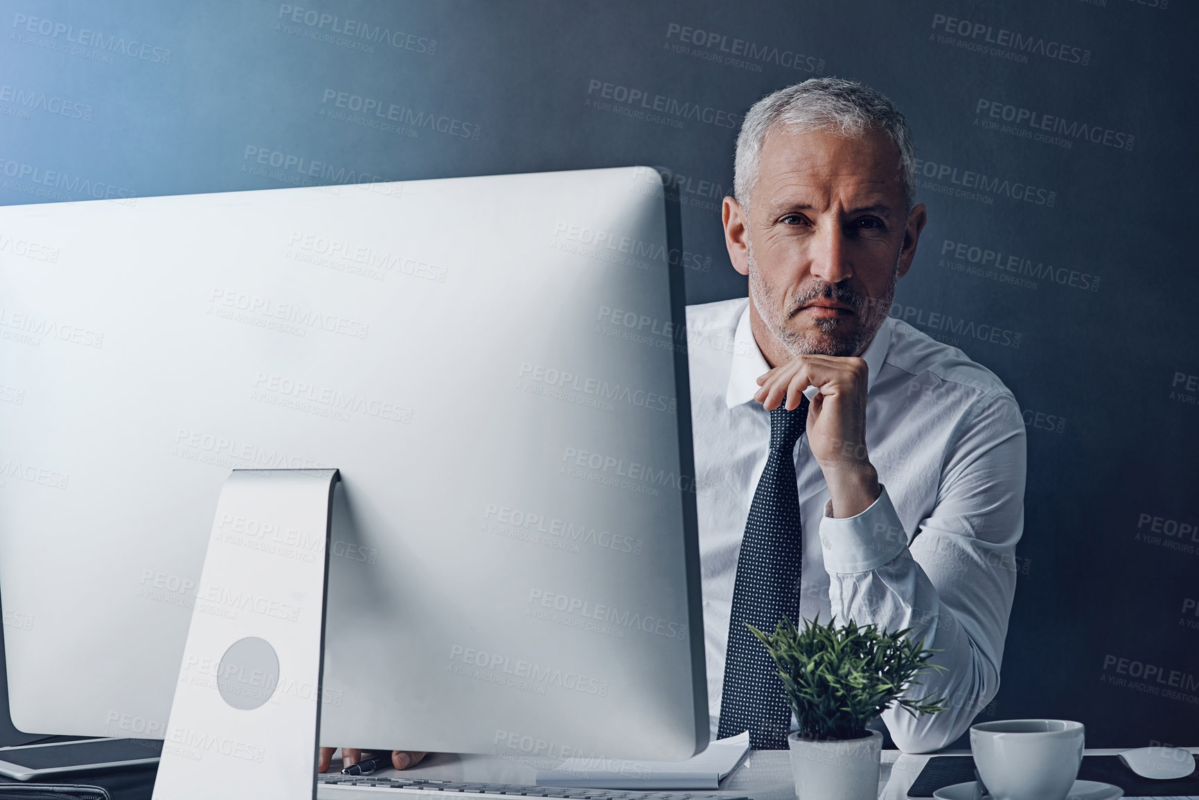 Buy stock photo Technology, mature man working on his computer and against a studio background. Connectivity or social networking, browsing internet or website and accountant research at desktop in backdrop 