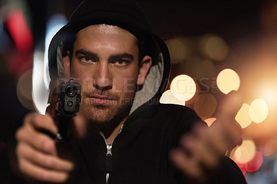 Buy stock photo Man, portrait and gun point in city as gangster thief with bokeh lights at night or robbery pistol, hoodie or dark. Male person, face and hand or downtown for dangerous crime or steal, thug or theft